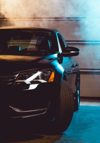 black-shiny-luxury-car-in-garage-with-smoke